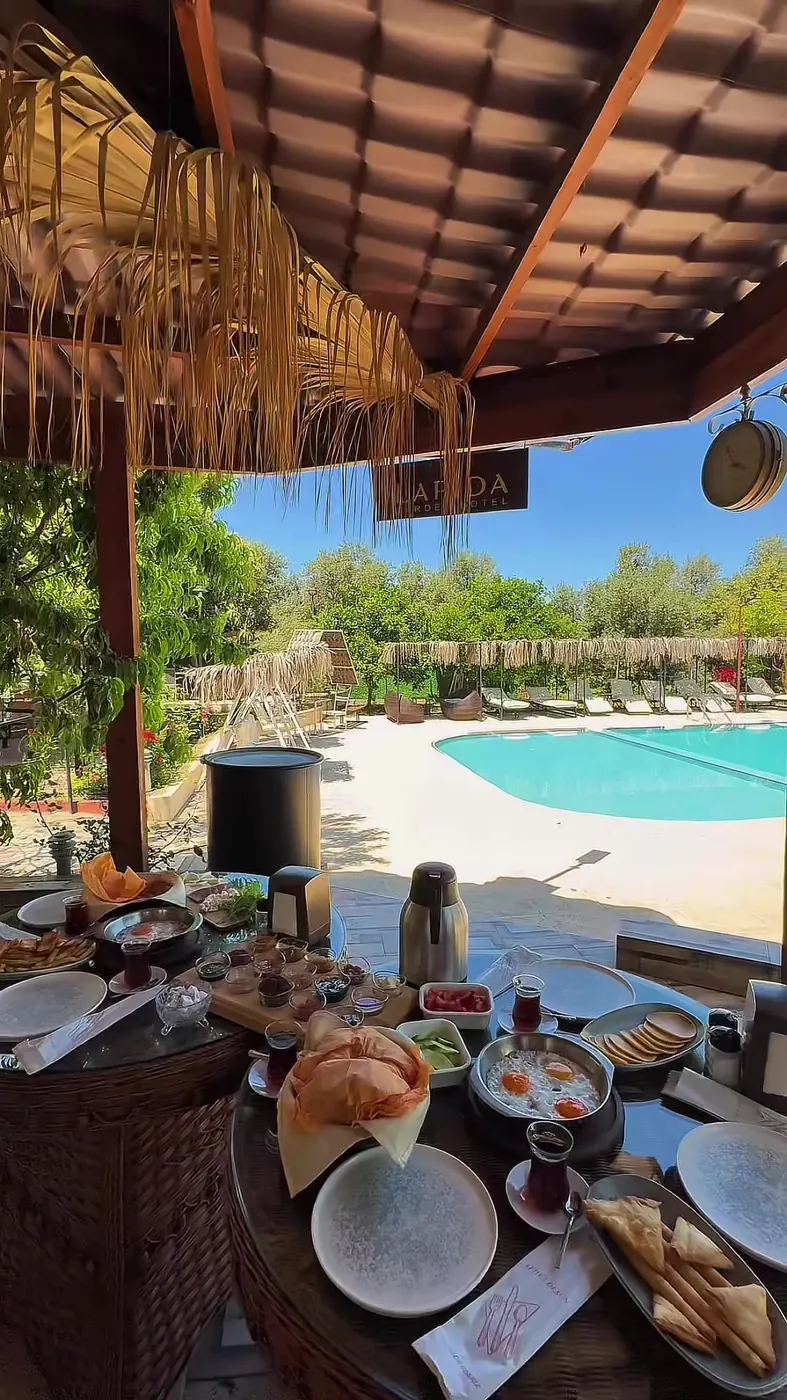 Breakfast spread on a table beside the pool